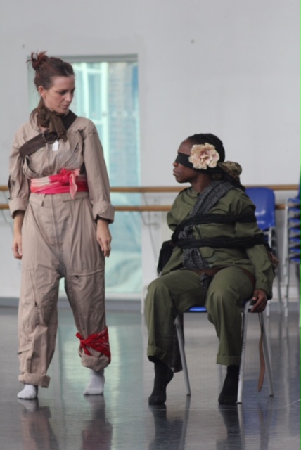 Two dancers in costume in rehearsal for performance