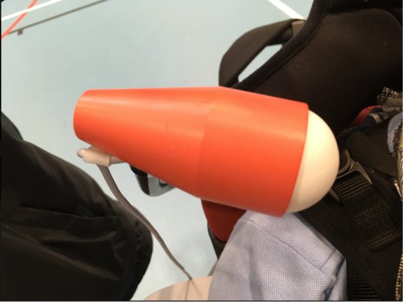 An orange plastic cone with a white ball on the end