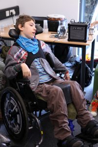 Young boy in wheelchair with music tech