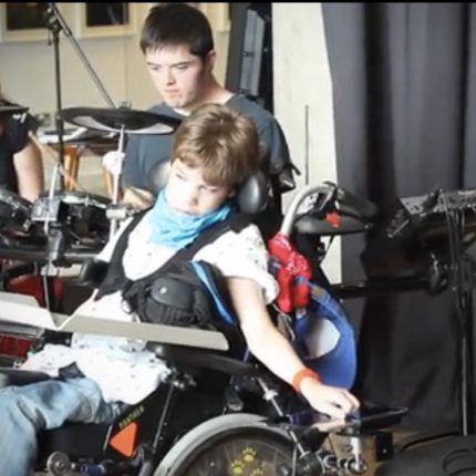 Image: still from video of 2 young people performing with drum and switches
