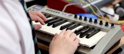 Keyboard in close up, with hands playing
