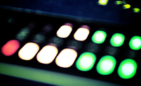 Image: green amber and red sound level lights on a mixing board
