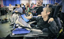 Image: still from video showing group of disabled musicians using iPads