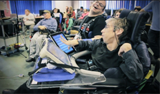 Image: still from video showing group of disabled musicians using iPads