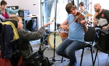 Young musicians playing violin, other instruments and conducting