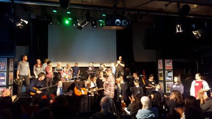 Conference stage with musicians playing instruments