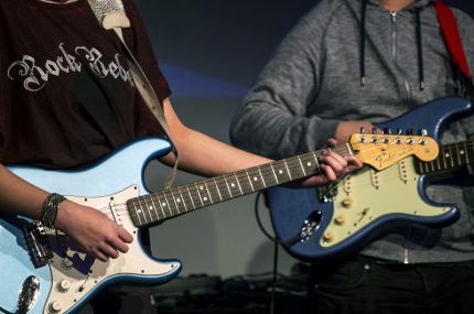 Close up of a guitar played by Royal Boil Alice