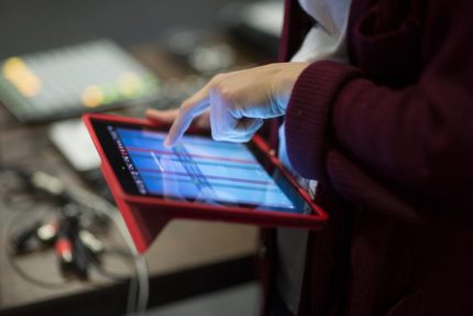 Hand pressing iPad screen