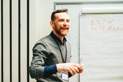 Jonathan presents with a smile in a breakout session