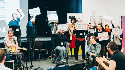 the Drake Music team take to the stage with protest signs