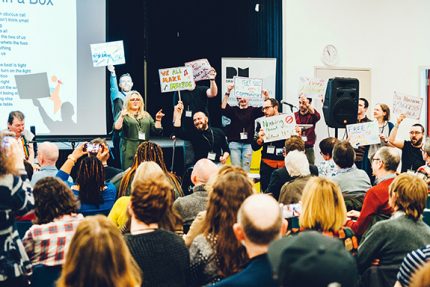 The Drake Music team take to the stage with protest signs