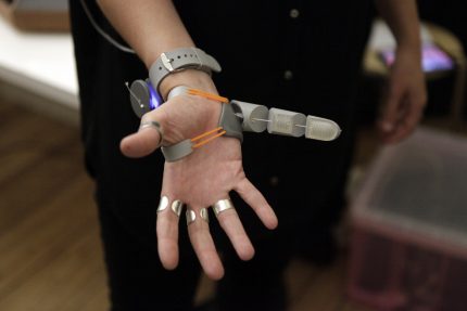 Close up on the third thumb - a plastic jointed thumb device which attaches to the hand opposite the actual thumb