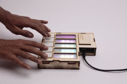 Jammies, an instrument similar to the form factor of that of a piano but with just 5 rectangular keys and LED strips for each of those keys.