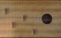 Picture of wooden musical instrument taken from above. The instrument is rectangular and has 5 sets of 6 strings, each with a bridge located at different points up the length of the strings. There is a sound hole and to the left of the sound hole there is a label which says “Pentachord”. Each group of strings is labelled with a different coloured dot sticker, and there are lines going across like frets labelled with note names at the top and bottom.