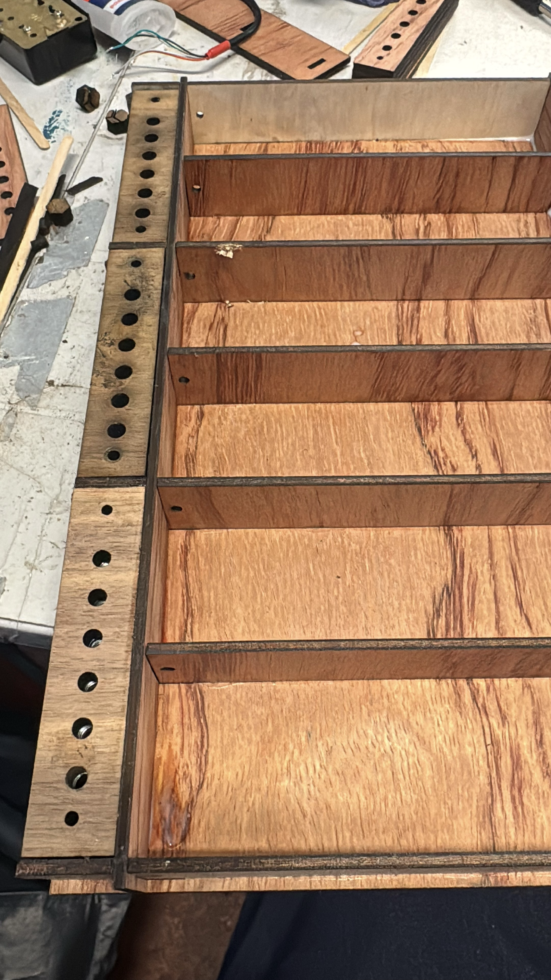 Inside the pentachord - 6 seperate wooden compartments divided by a piece of wood.