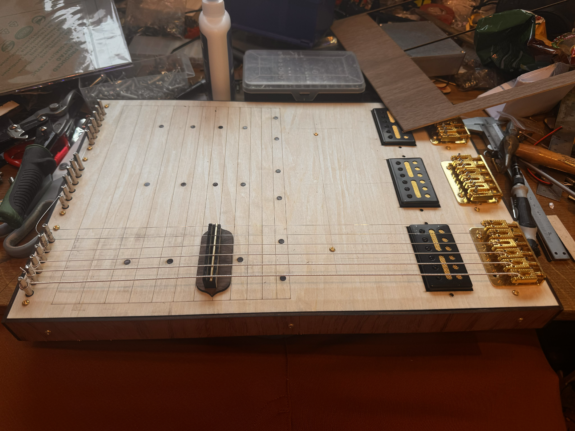 A picture of the unfinished Pentachord lying on a workbench.
